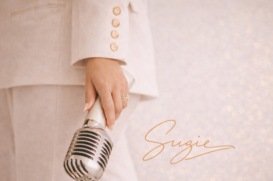Vocals by Suzie branded image with vintage microphone and signature logo