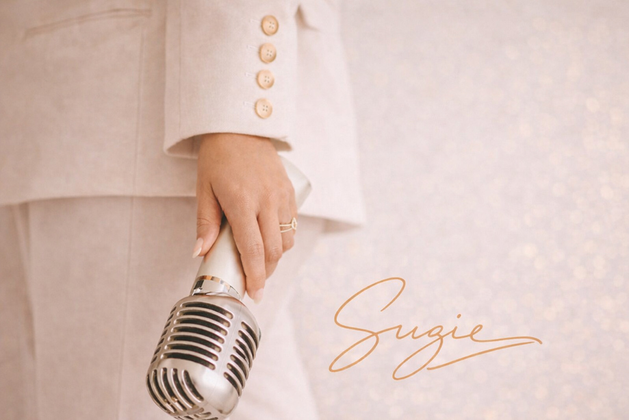 Vocals by Suzie branded image with vintage microphone and signature logo