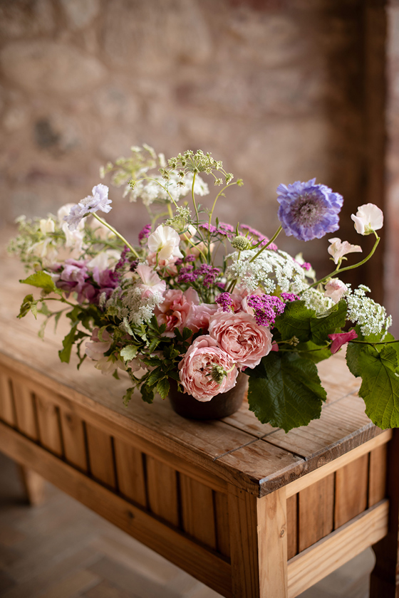 Pastel wedding flower arrangement with pink roses and lilac blooms by Agapanthus Flower Studio