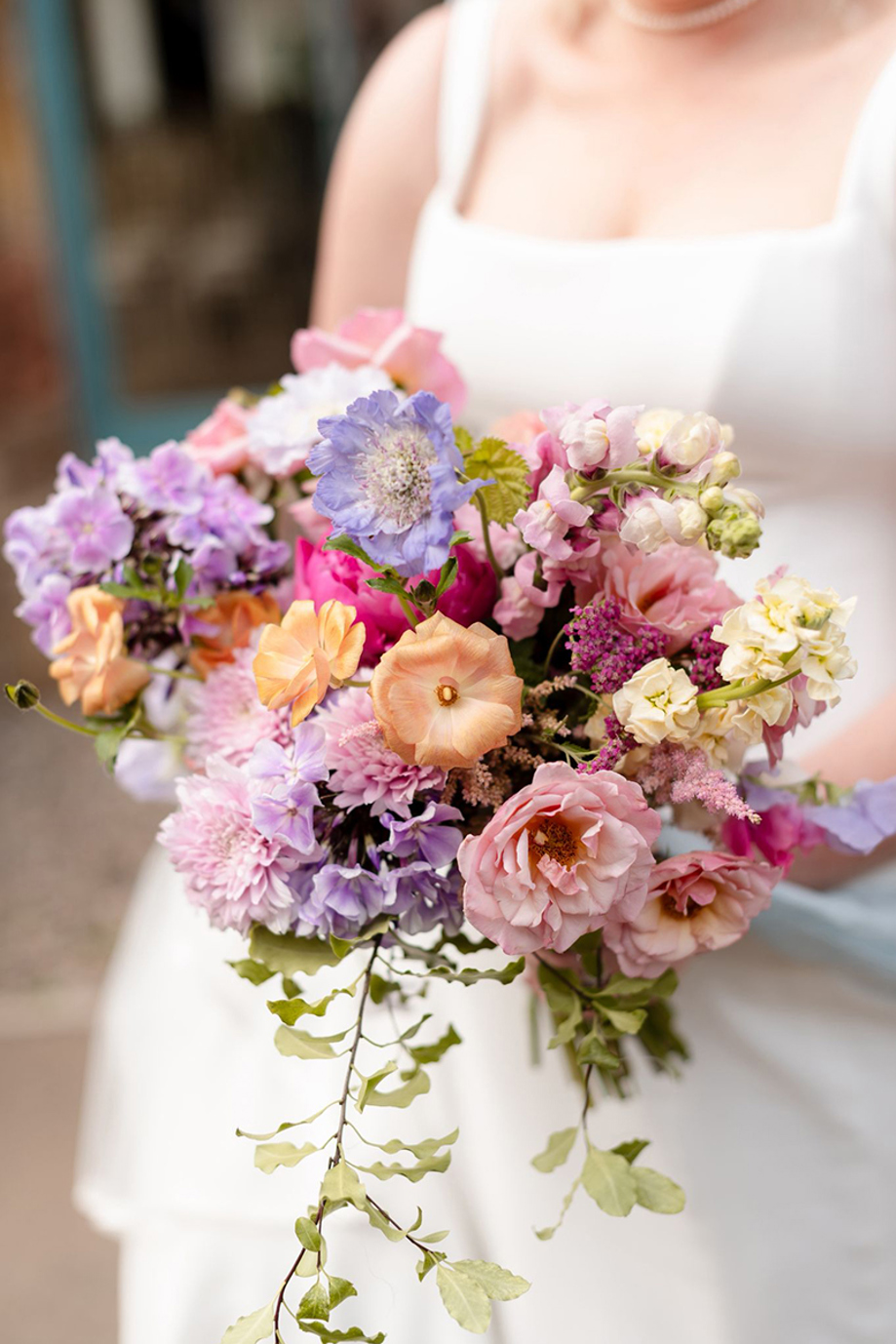 Bride holding a colourful pastel wedding bouquet by Scottish florist Agapanthus Flower Studio
