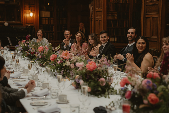 Long wedding banquet table dressed with summer flowers by Agapanthus Flower Studio
