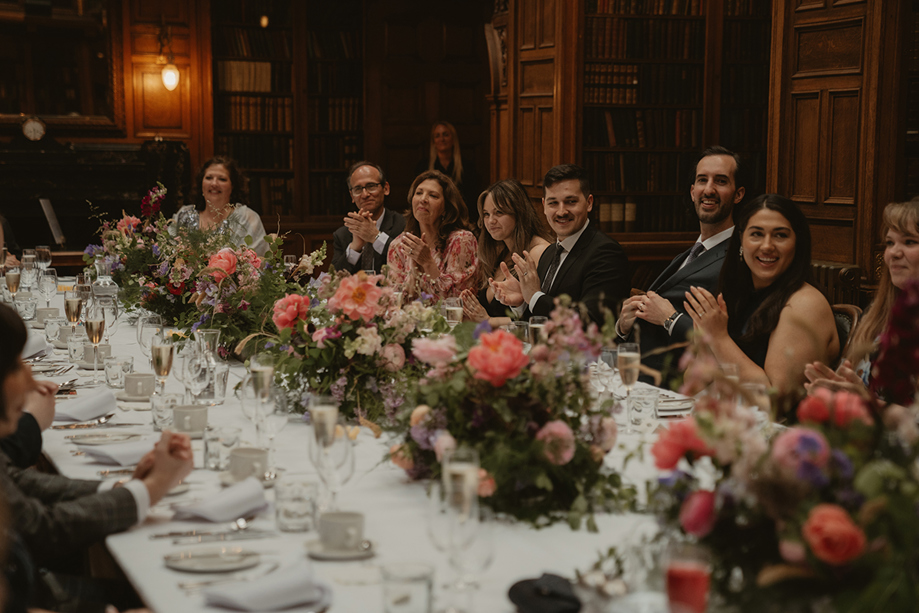 Long wedding banquet table dressed with summer flowers by Agapanthus Flower Studio
