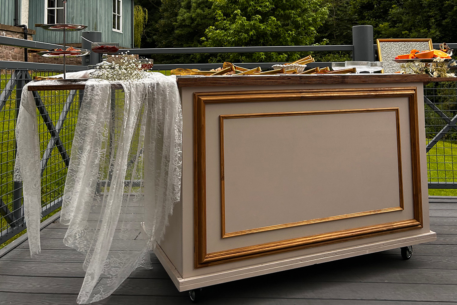 Bramble & Brie wedding grazing cart decorated with lace and gold detailing for an outdoor celebration