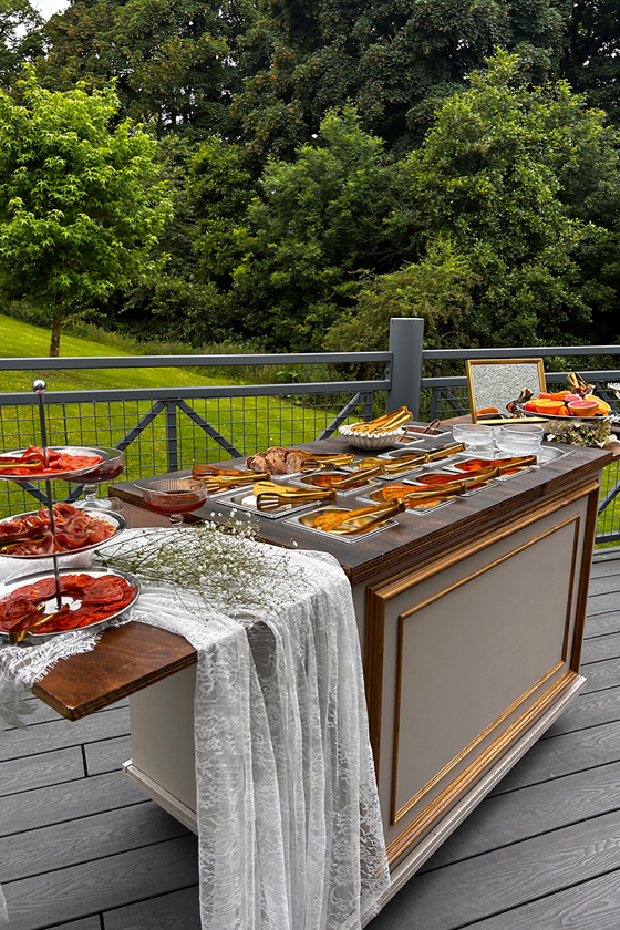 Bramble & Brie outdoor wedding grazing table with meats, cheeses, breads and fresh fruit