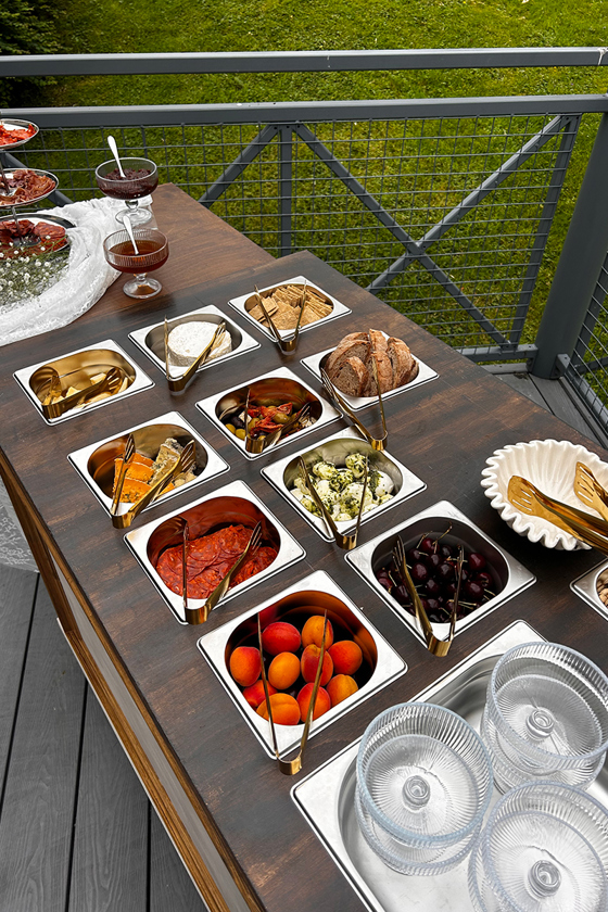 Outdoor wedding grazing table by Bramble & Brie with cheese, charcuterie, bread, fruit and antipasti