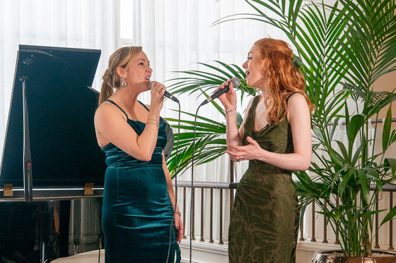 Copper Blonde wedding singers performing a duet beside a grand piano