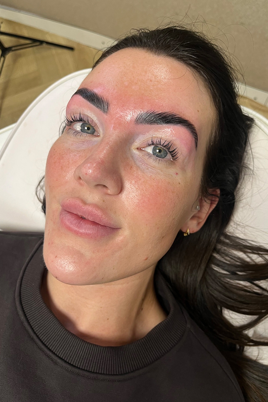 Close-up of a Browz & Bronze by Leah client showing freshly styled, defined brows and lifted natural lashes.