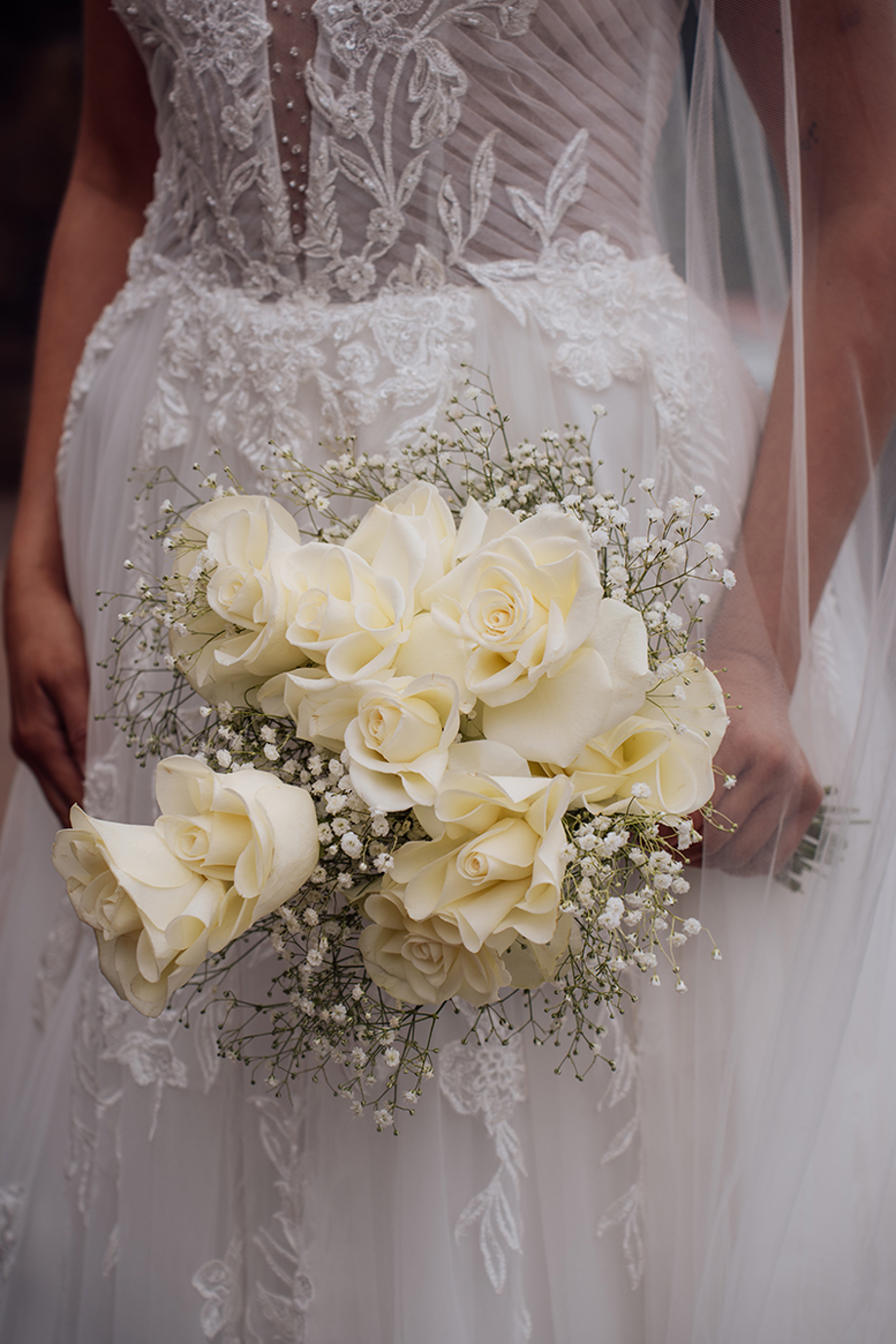 Close-up of a classic white rose and gypsophila bridal bouquet styled by Maison Bloom Florals.