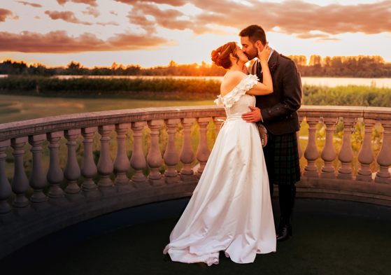 Bride and Groom embracing at Sunset on balcony at Gailes Ayrshire