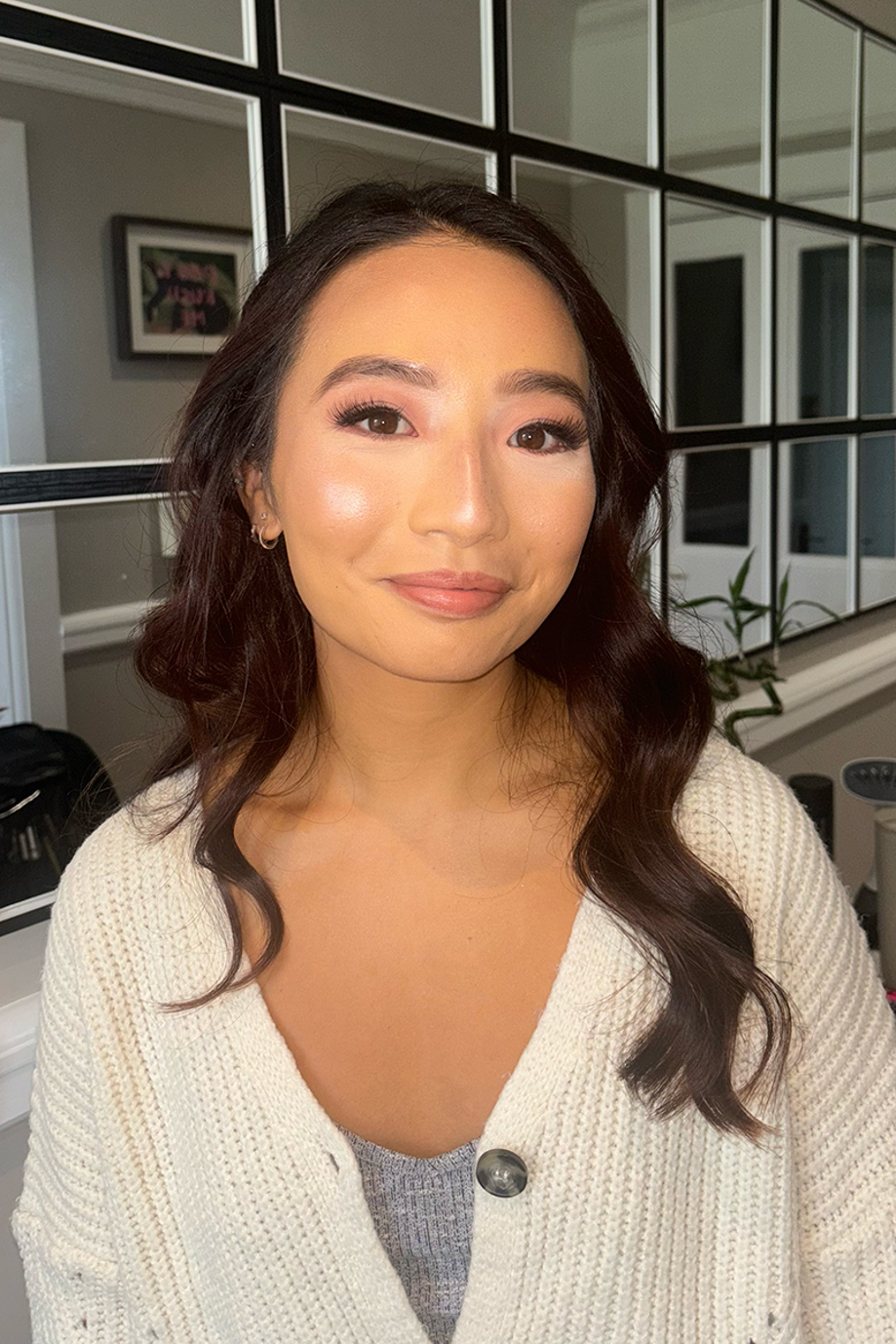 Client with softly curled hair, glowing skin and natural wedding makeup by Scottish hair and makeup artist Bridal by Regina.