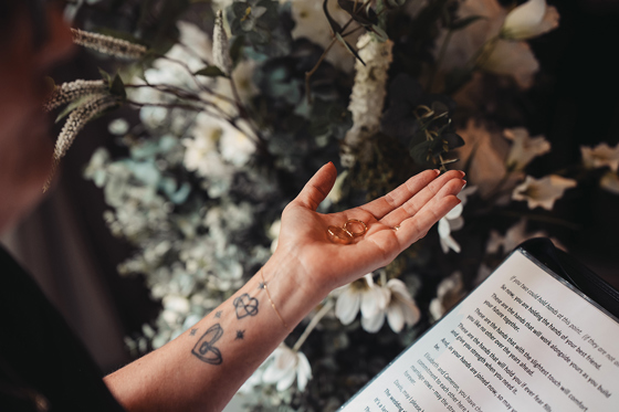 Fiona MacAlister Celebrant holds the couple’s wedding rings in her hand during a personalised Scottish wedding ceremony.