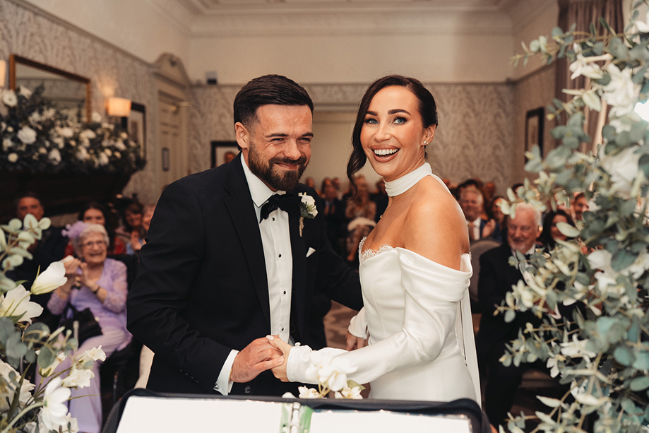 Bride and groom laugh together at the altar during their wedding ceremony with Fiona MacAlister Celebrant.
