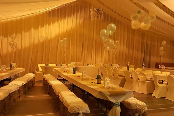 Barn reception at Geilsland Estate with hay bale seating.