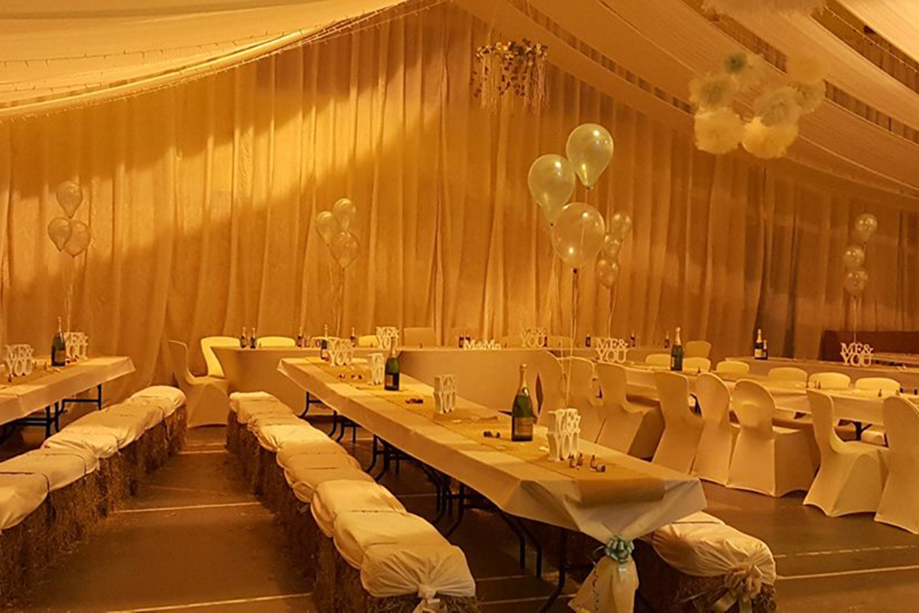 Barn reception at Geilsland Estate with hay bale seating.