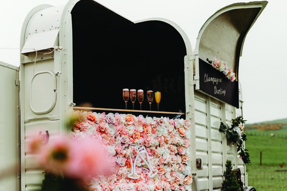 Horseshoe box bar with flowers and blackboard on front at Maycroft Retreat in Perthshire.