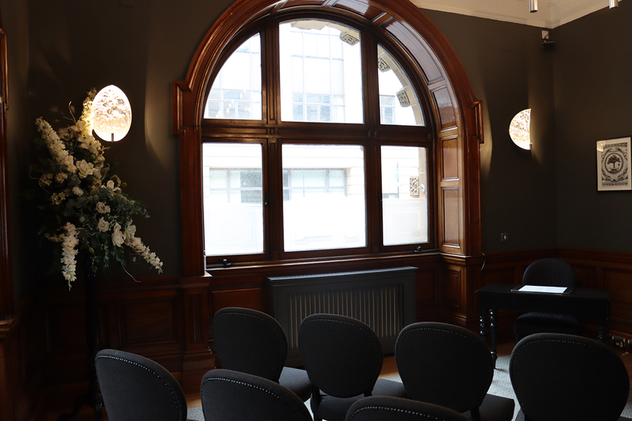 Arched window in dark, moody room