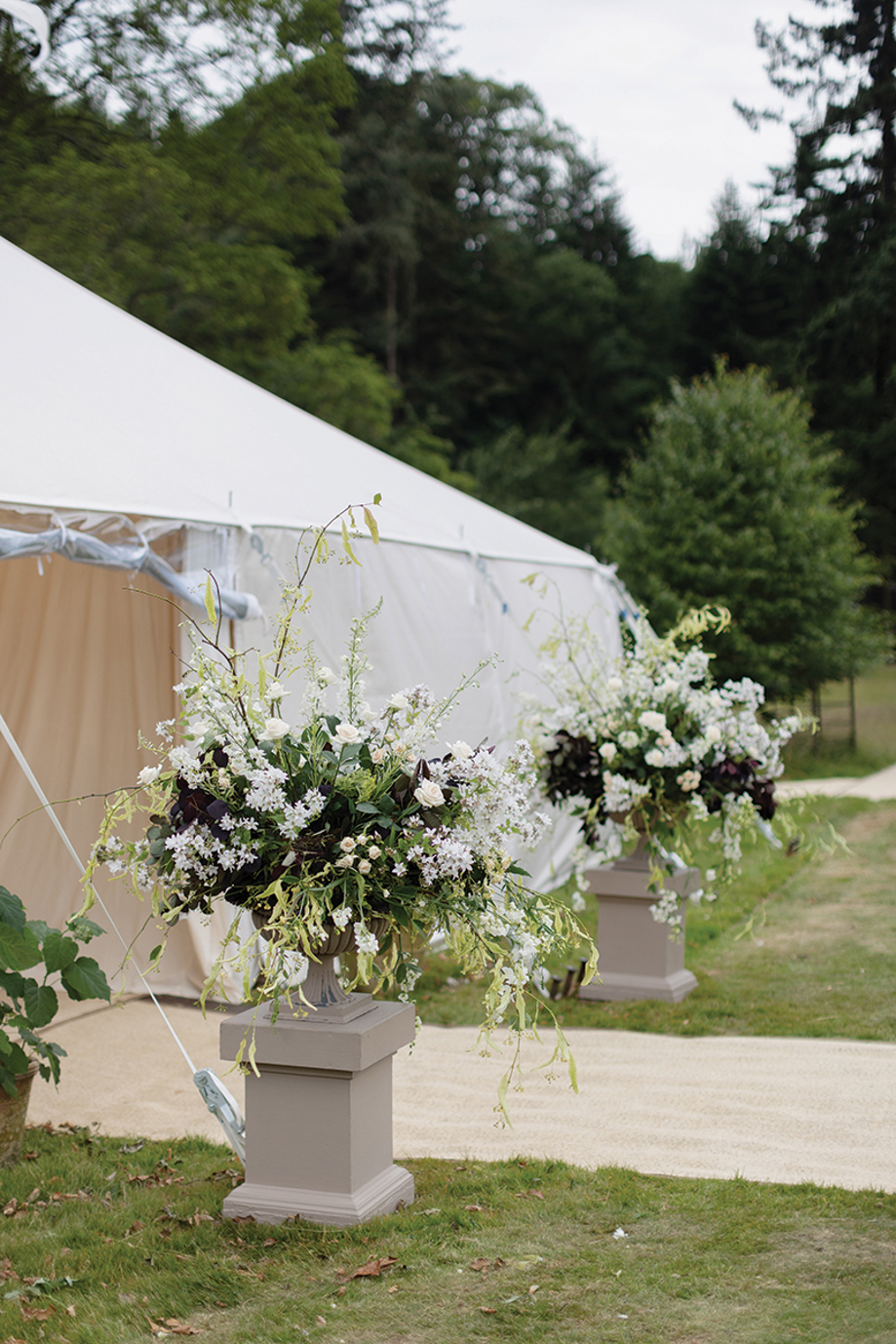Entrance to marquee on lawns of Newton Don Estate, with white and green flowers at entrance.