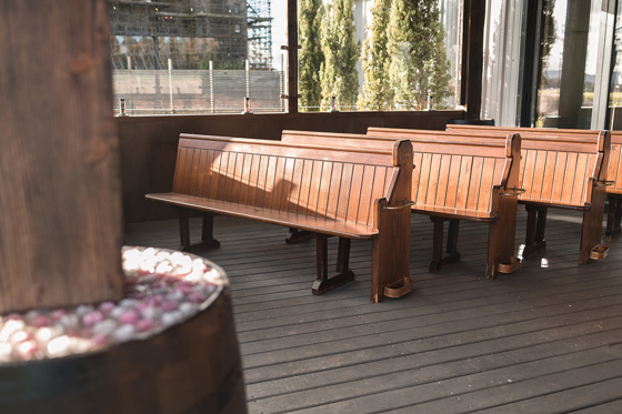 Wooden pew seating for ceremony at The Venue @ Duntarvie Castle, rustic outdoor wedding space with countryside views in West Lothian.