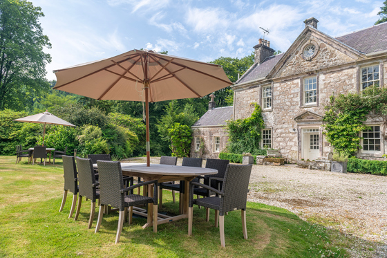 Outdoor seating and landscaped gardens at Broomholm Manor, ideal for wedding drinks receptions and private stays.