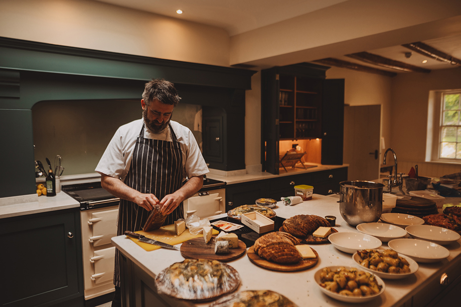 Private chef preparing a bespoke dining experience in the kitchen at Broomholm Manor.