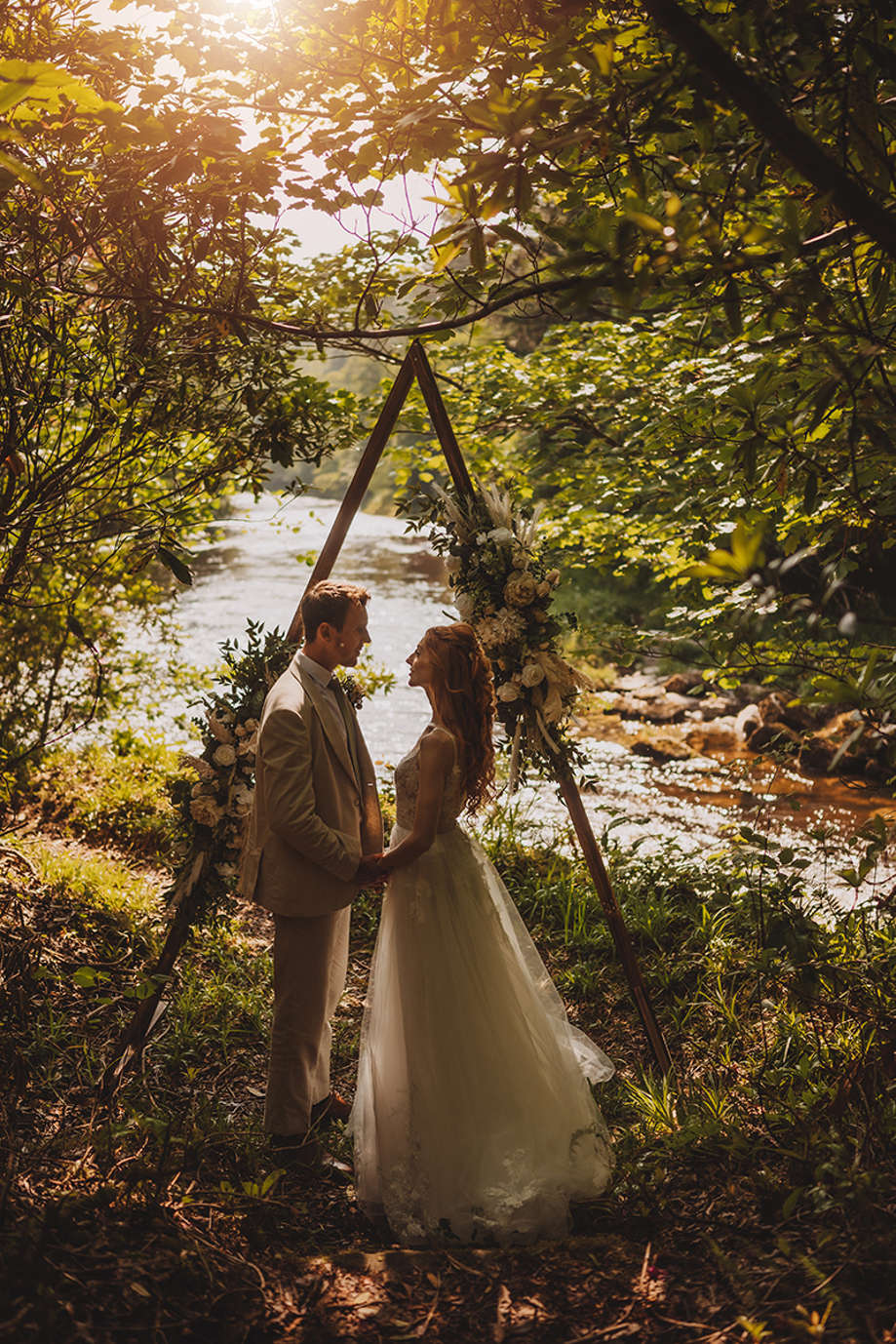 Bride and groom at a riverside wedding ceremony location within the grounds of Broomholm Manor.