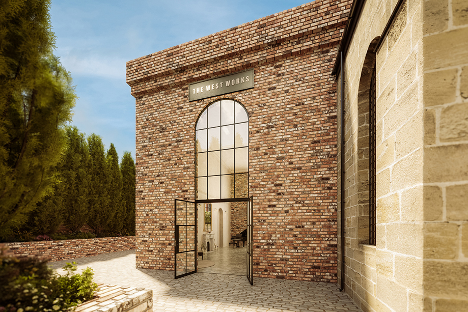 Side entrance to The West Works Glasgow with red brickwork, arched window and black framed glass doors