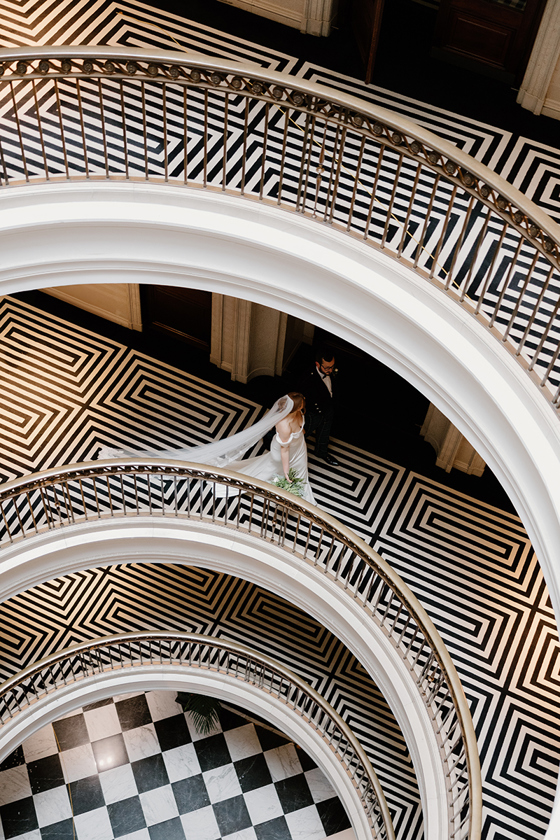 Bride and groom pictured on the curved staircase at The Edinburgh Grand, Edinburgh.