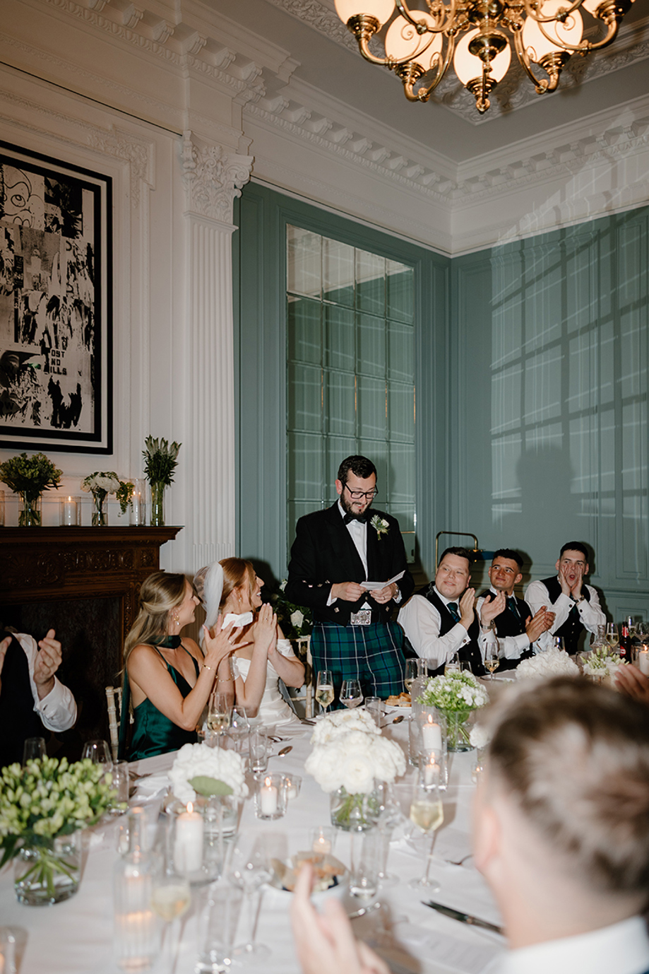 Groom gives a speech during the wedding reception at The Edinburgh Grand as guests applaud.