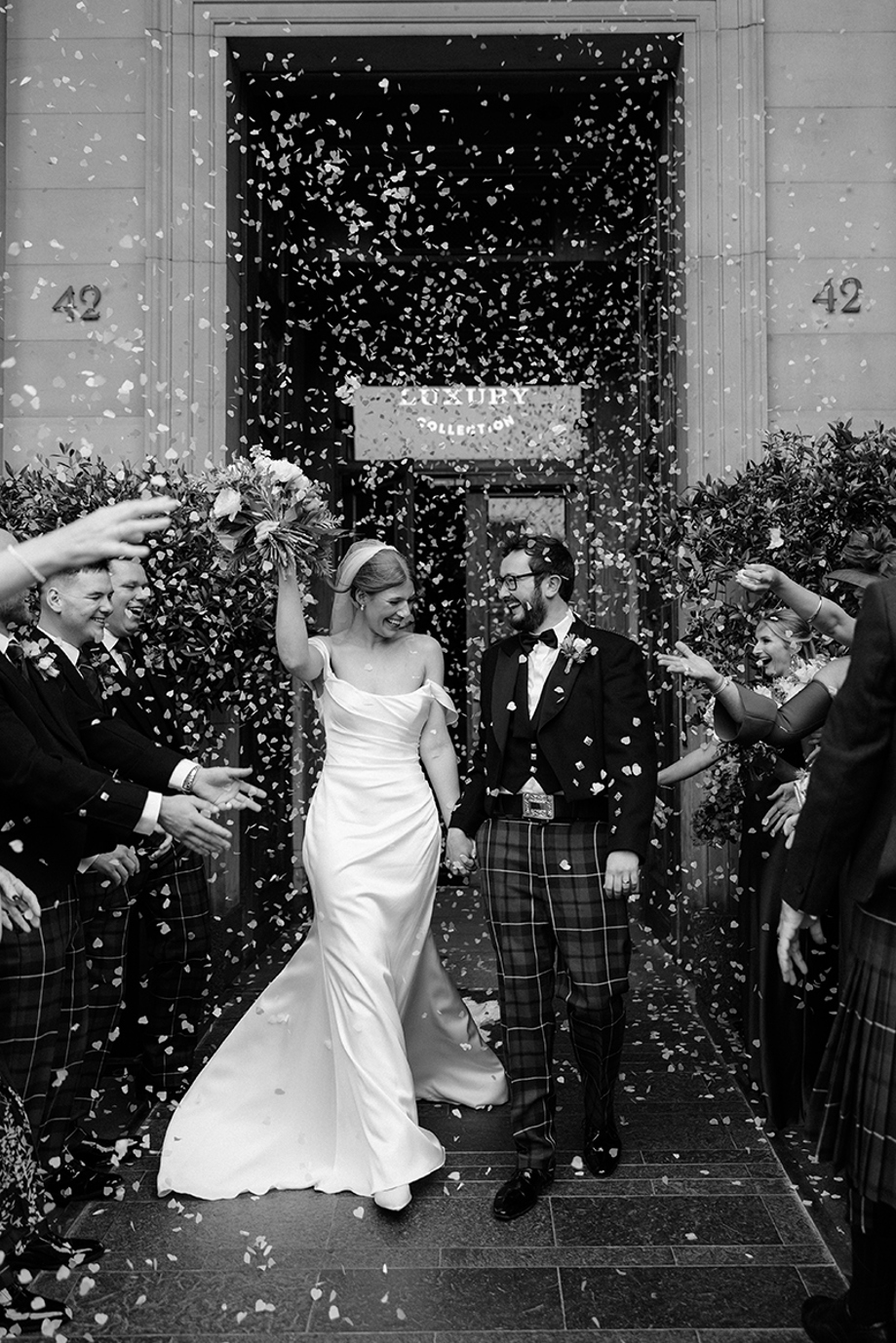 Bride and groom walk through confetti outside The Edinburgh Grand after their wedding, photographed by Jennifer Glen Photography.