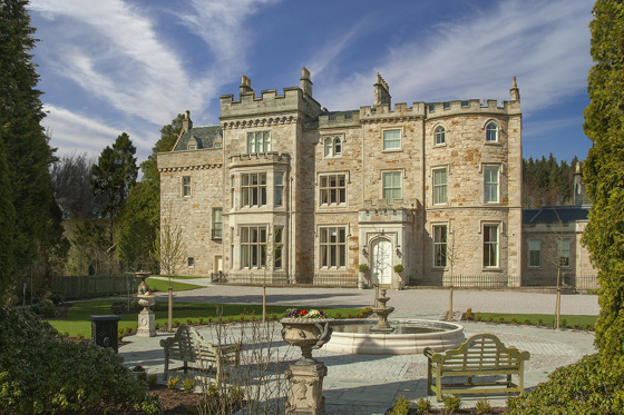 Exterior of Crossbasket Castle with fountain and benches in foreground