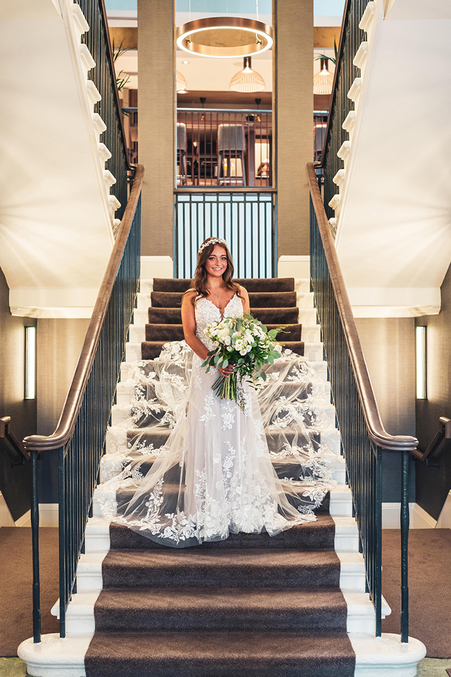 Bride stands on stairs at The Clayton Hotel in Glasgow