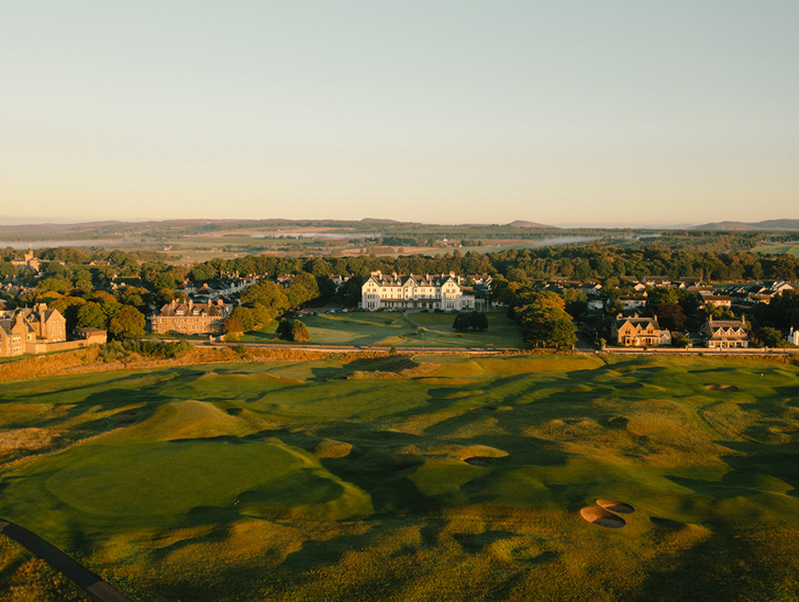 Aerial view of Dornoch Station Hotel wedding venue with championship golf course in the foreground and Scottish Highlands landscape beyond