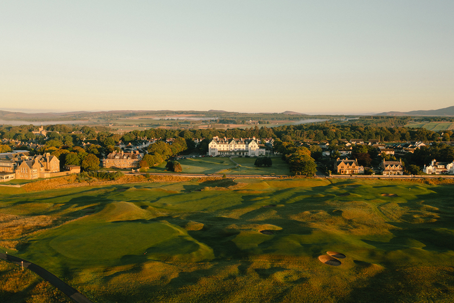 Aerial view of Dornoch Station Hotel wedding venue with championship golf course in the foreground and Scottish Highlands landscape beyond