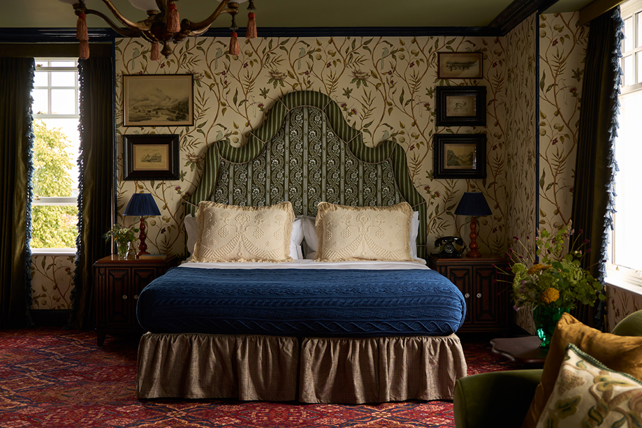 King Suite bedroom at Dornoch Station Hotel with patterned wallpaper, upholstered headboard and traditional Scottish interiors
