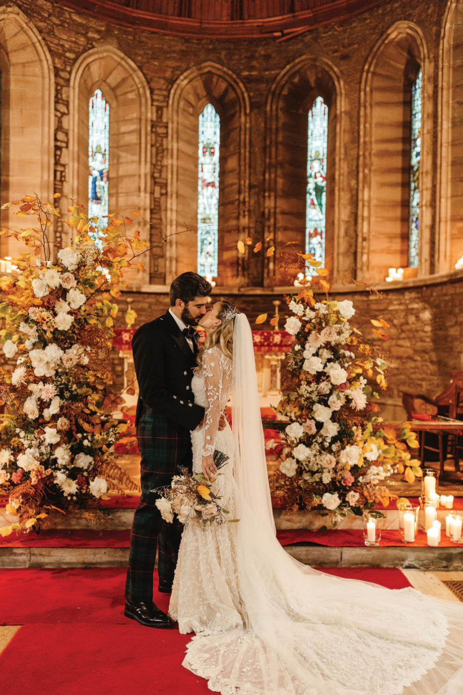 Bride and groom kissing during their wedding ceremony inside Drumtochty Castle chapel, Aberdeenshire.