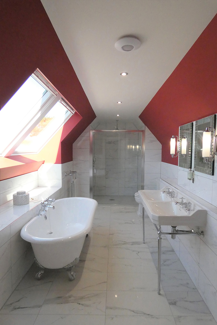 Red and white decorated bathroom at Dungallan Country House, with a white claw foot bath.