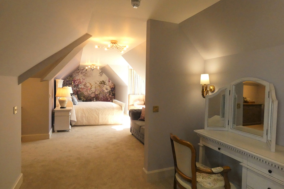 Honeymoon suite with natural light flooding through its windows at Dungallan Country House in Oban.