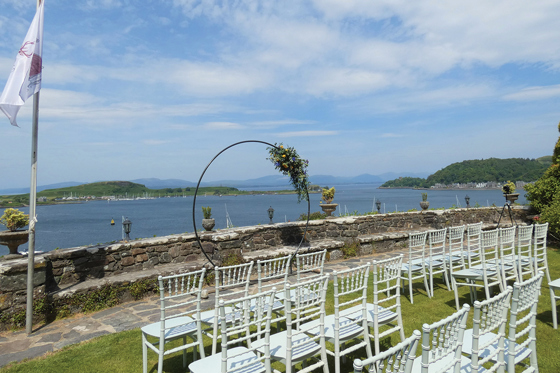 Outdoor ceremony set up on the grounds of Dungallan Country House with hoop at altar and views across the water.