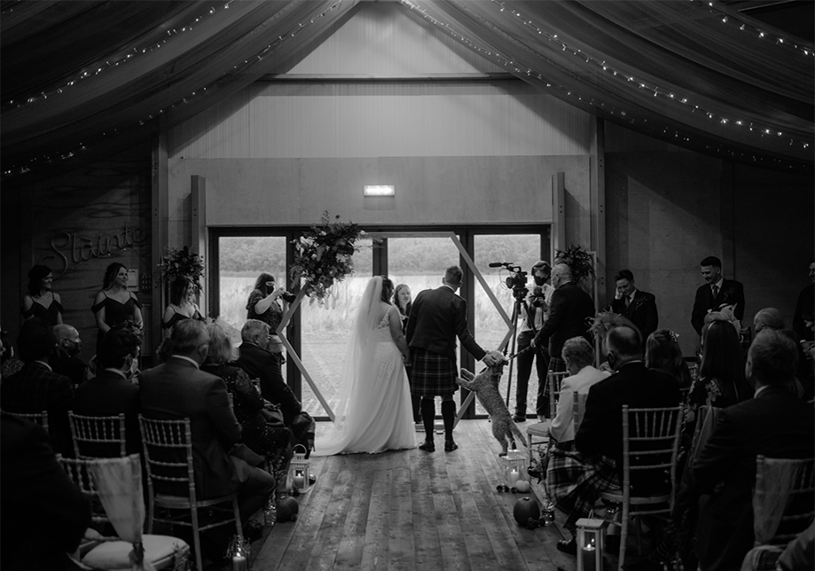 Black and white image of bride and groom at the altar