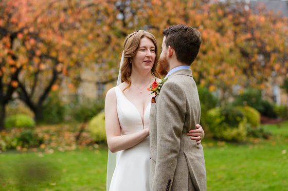Bride and groom talk whilst standing in Blythswood Square gardens