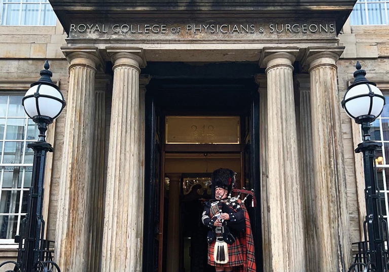 Bagpiper playing at main entrance to 1599 at the Royal College