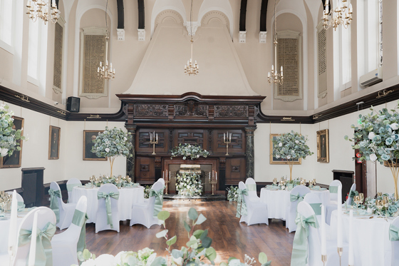 Reception set up at 1599 at the Royal College with sage green accents.