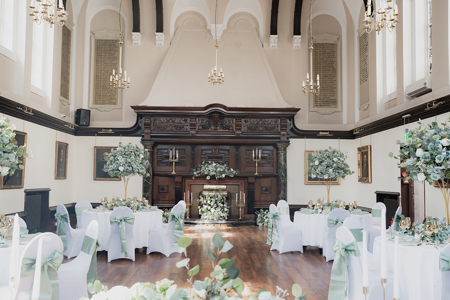 Reception set up at 1599 at the Royal College with sage green accents.