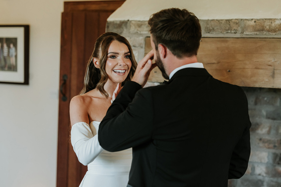 Bride comforts her groom as he cries during first look at Harelaw Farm.