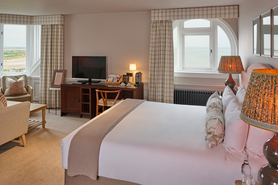 Cosy bedroom at Hotel du Vin St Andrews, with soft brown accents and gingham curtains.