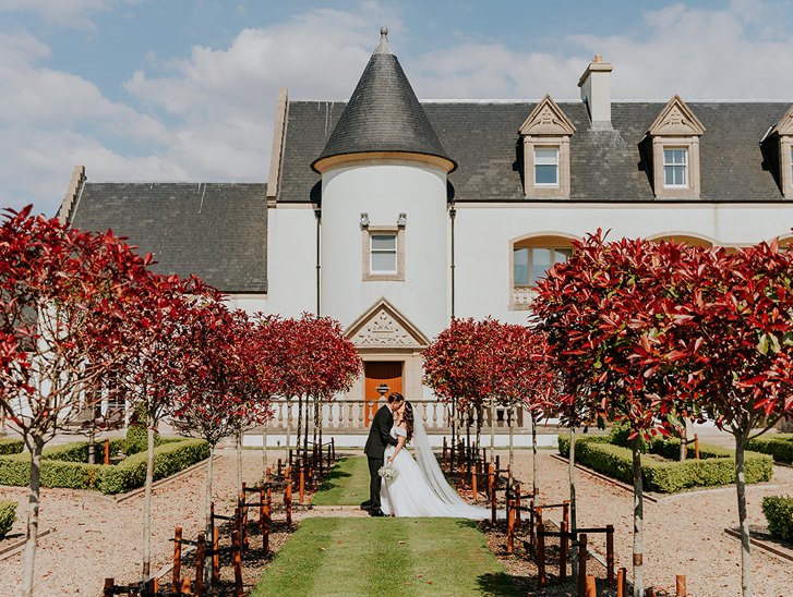 Bride and groom portrait in formal gardens at Ingliston Estate and Country Club in Bishopton