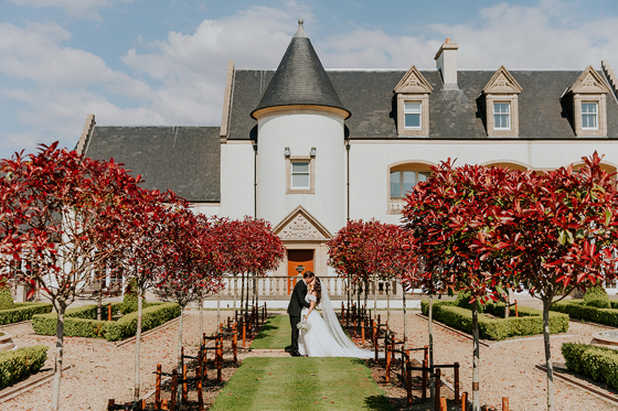 Bride and groom portrait in formal gardens at Ingliston Estate and Country Club in Bishopton