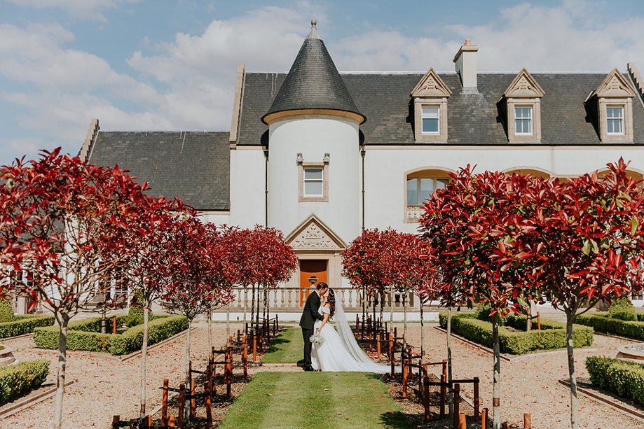 Bride and groom portrait in formal gardens at Ingliston Estate and Country Club in Bishopton