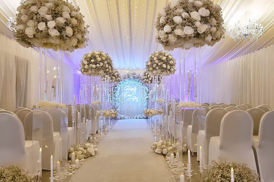 Luxury white wedding ceremony setup with floral aisle styling at Ingliston Estate and Country Club