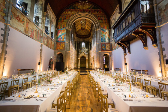 Long tables decorated with candles and gold decor